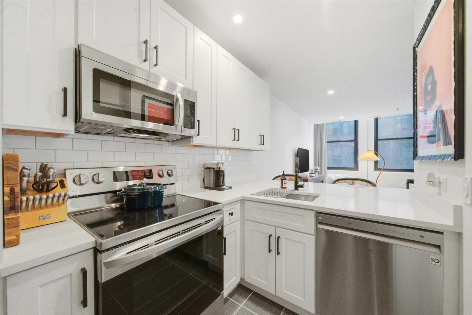 680 South Federal Street, Unit 807 Chicago, IL 60605 - Photo 3 of 17 a kitchen with stainless steel appliances a sink a stove a microwave a sink and cabinets