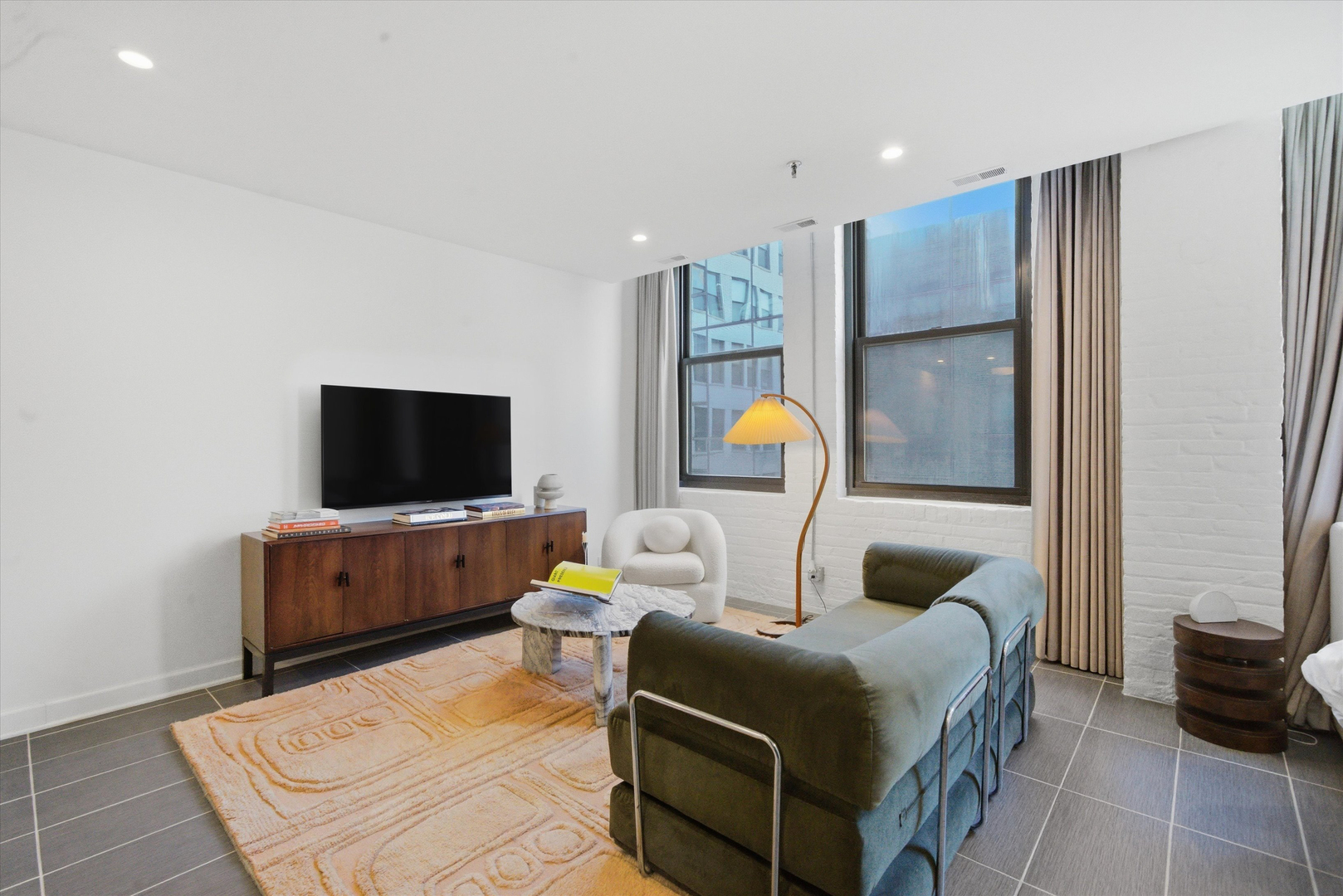 680 South Federal Street, Unit 807 Chicago, IL 60605 - Photo 6 of 17 a bedroom with a bed and flat screen tv