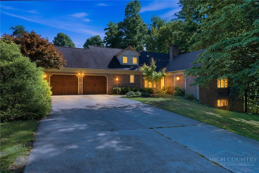 304 Glendale Drive Boone, NC 28607 - Photo 2 of 50 a front view of a house with a yard and a garage