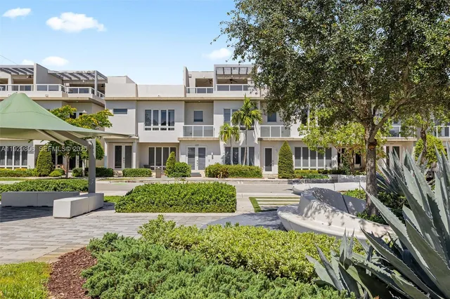 a front view of a building with a garden