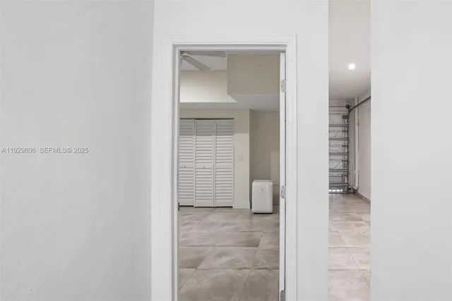 a view of a hallway with wooden shelves