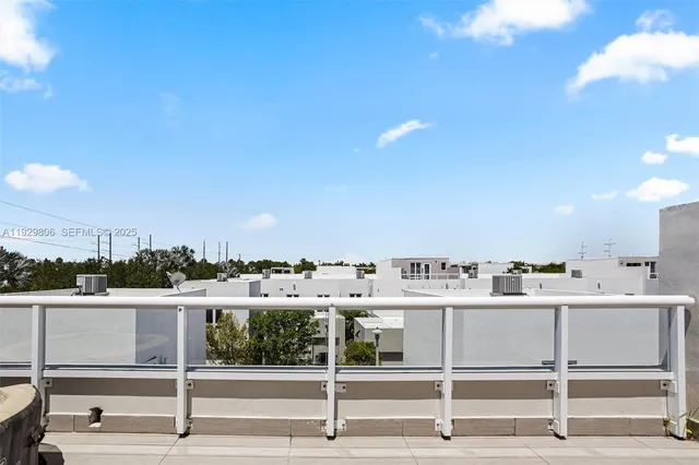 a view of a kitchen with a sink and dishwasher with a fireplace