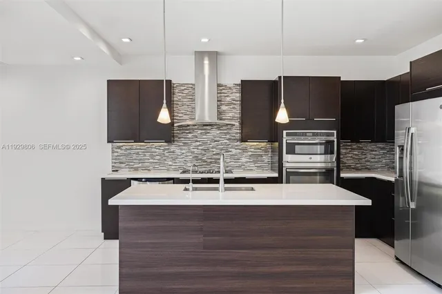 a kitchen with stainless steel appliances wooden cabinets and granite counter tops