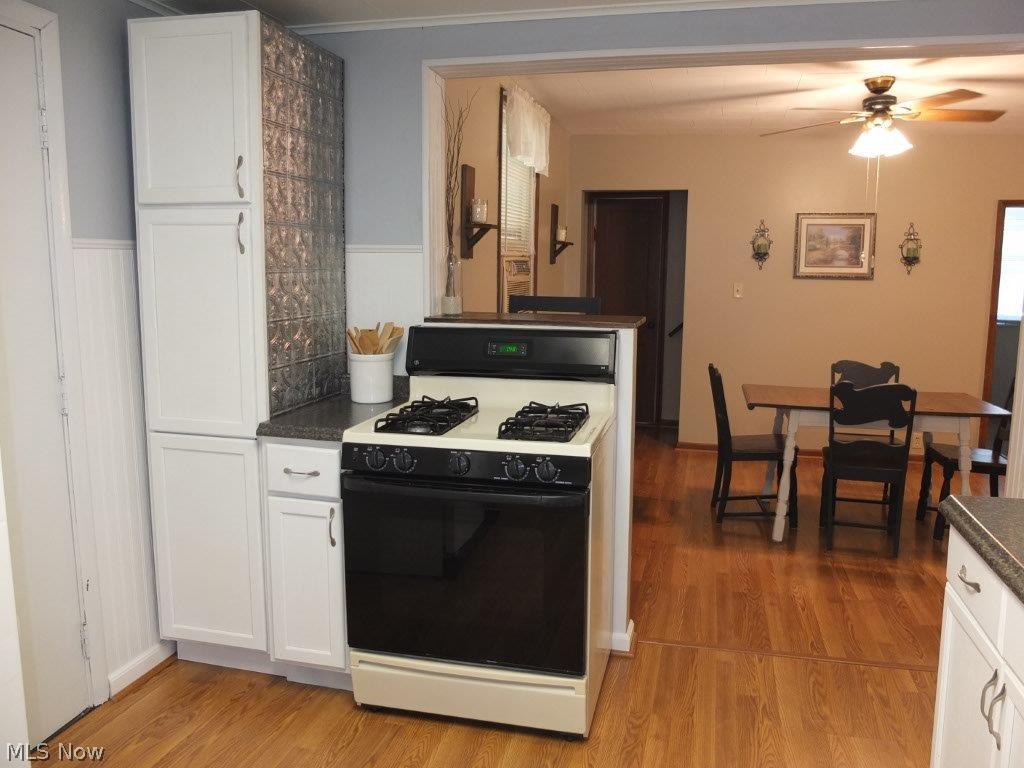 Applianced kitchen with oven, range and refrigerator.