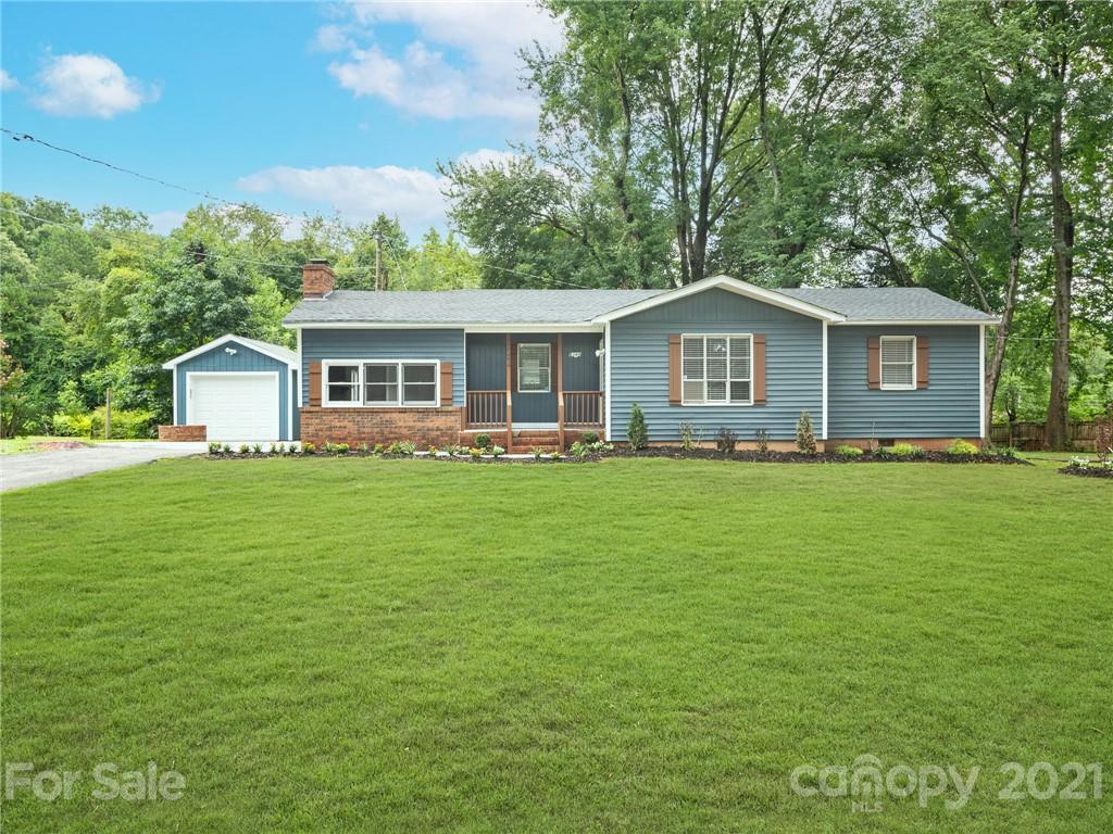 a front view of house with yard and green space
