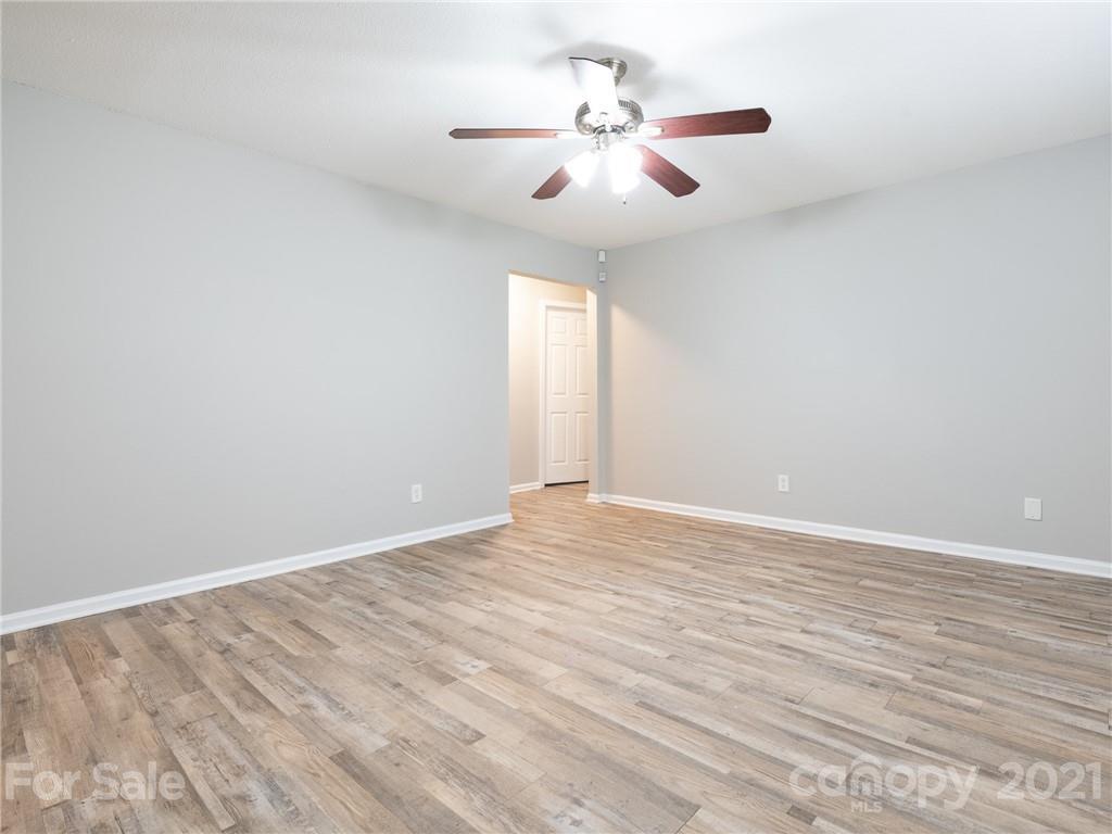 5344 Rockwood Road Charlotte, NC 28216 - Photo 11 of 31 a view of an empty room with wooden floor