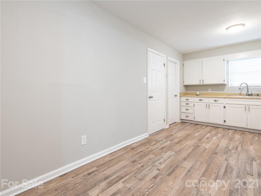 5344 Rockwood Road Charlotte, NC 28216 - Photo 13 of 31 a view of a kitchen with wooden floor and window