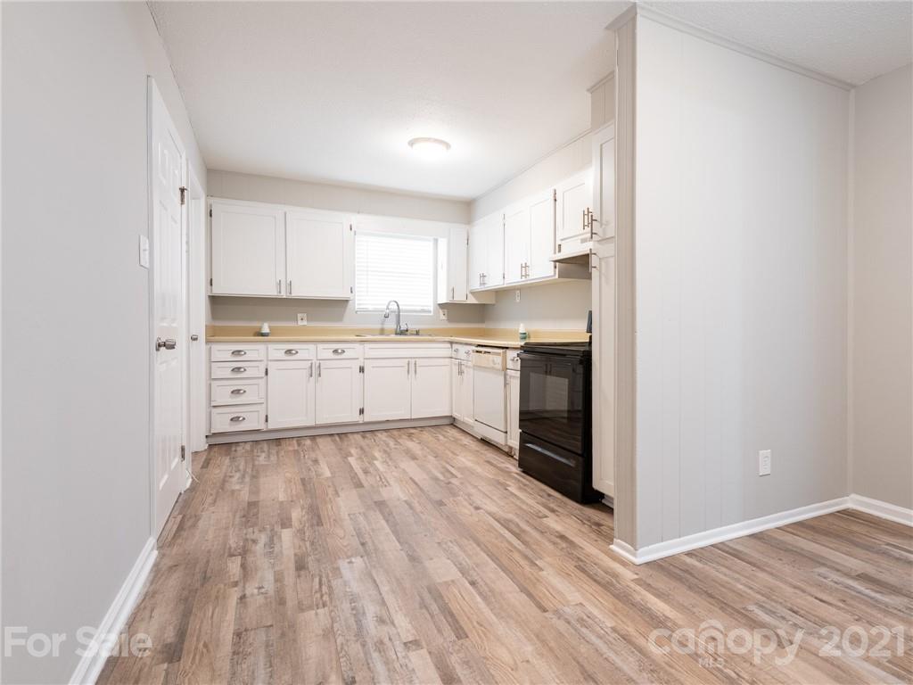 5344 Rockwood Road Charlotte, NC 28216 - Photo 14 of 31 a view of a kitchen with wooden floor and electronic appliances