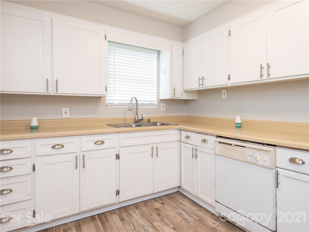 5344 Rockwood Road Charlotte, NC 28216 - Photo 15 of 31 a kitchen with granite countertop white cabinets white appliances and sink