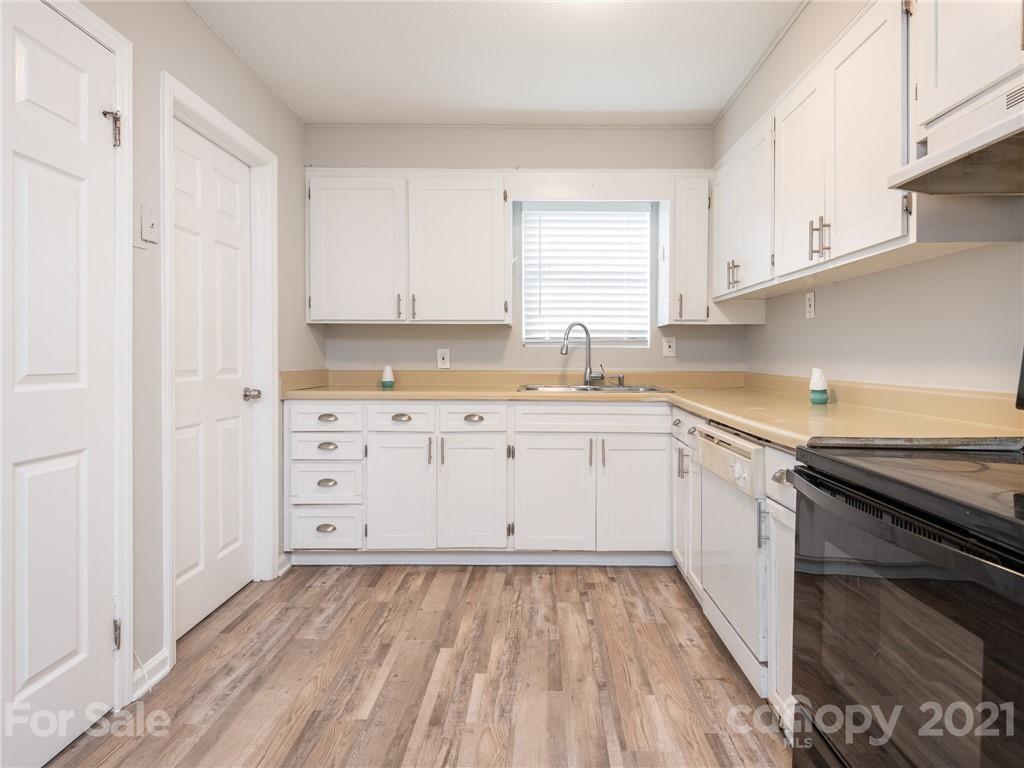 5344 Rockwood Road Charlotte, NC 28216 - Photo 16 of 31 a kitchen with granite countertop white cabinets and white appliances