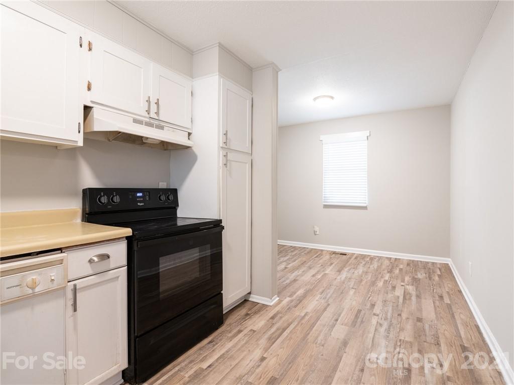 5344 Rockwood Road Charlotte, NC 28216 - Photo 17 of 31 a kitchen with granite countertop a stove and a sink