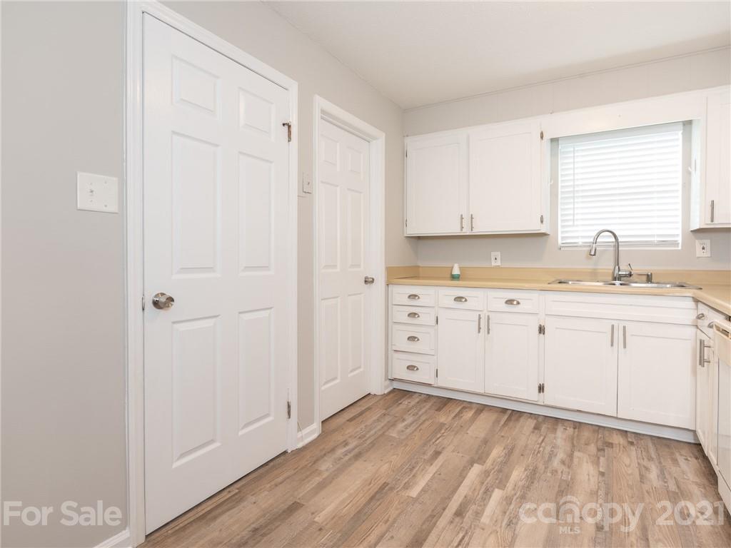 5344 Rockwood Road Charlotte, NC 28216 - Photo 18 of 31 a kitchen with a sink window and cabinets