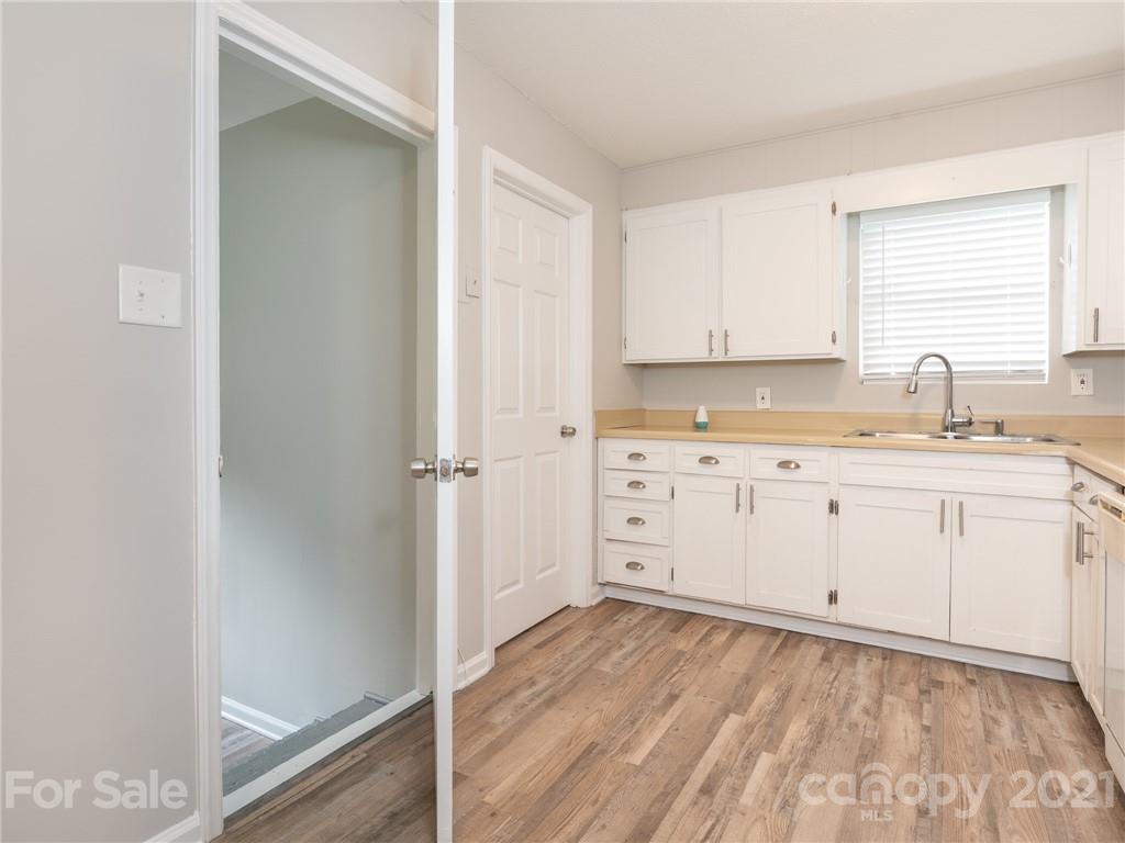 5344 Rockwood Road Charlotte, NC 28216 - Photo 21 of 31 a kitchen with a sink window and cabinets