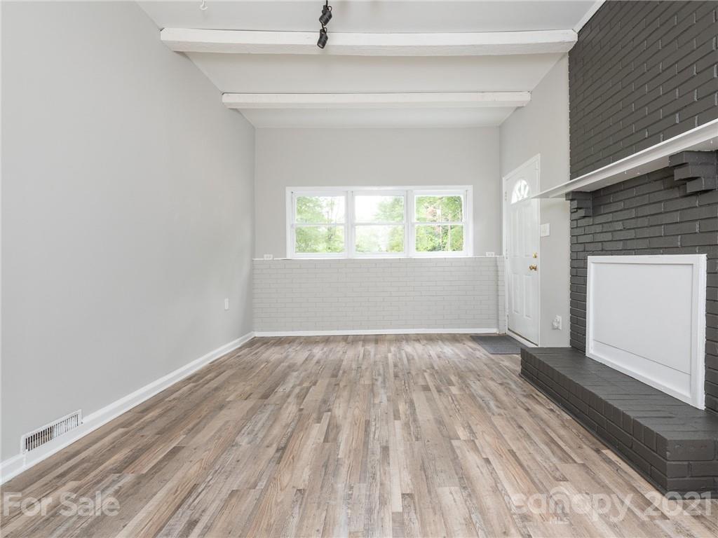 5344 Rockwood Road Charlotte, NC 28216 - Photo 22 of 31 an empty room with wooden floor and windows