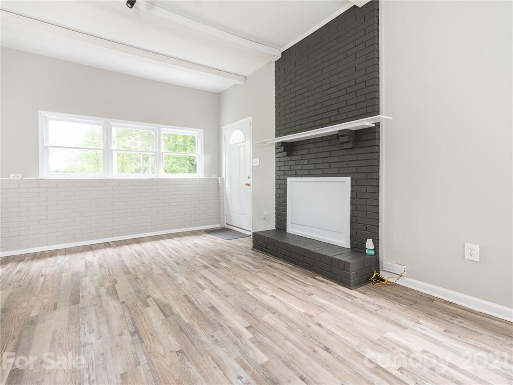 5344 Rockwood Road Charlotte, NC 28216 - Photo 23 of 31 a view of an empty room with a window and wooden floor