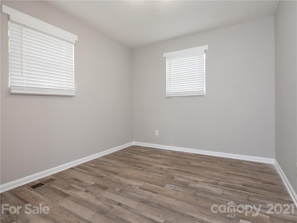 5344 Rockwood Road Charlotte, NC 28216 - Photo 25 of 31 wooden floor in an empty room with a window