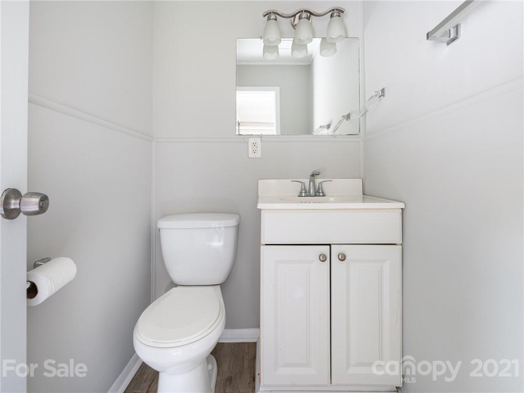 5344 Rockwood Road Charlotte, NC 28216 - Photo 26 of 31 a bathroom with a sink a toilet and a mirror