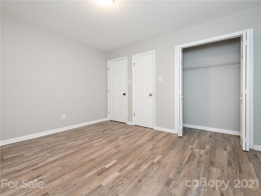 5344 Rockwood Road Charlotte, NC 28216 - Photo 4 of 31 a view of an empty room with wooden floor
