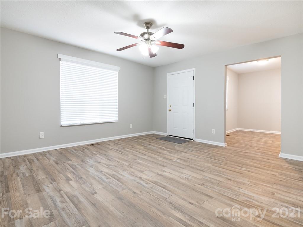 5344 Rockwood Road Charlotte, NC 28216 - Photo 9 of 31 wooden floor in an empty room with a window