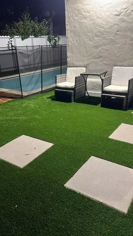 a view of a garden with lawn chairs