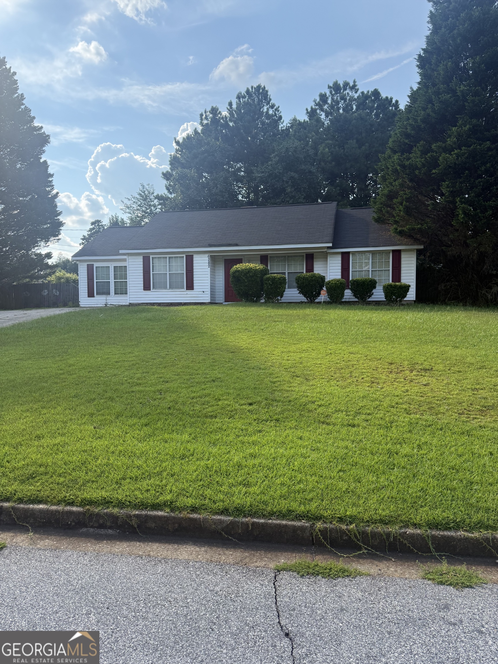 a front view of a house with a garden