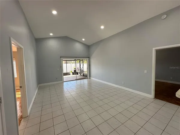 an empty room with windows and entrance