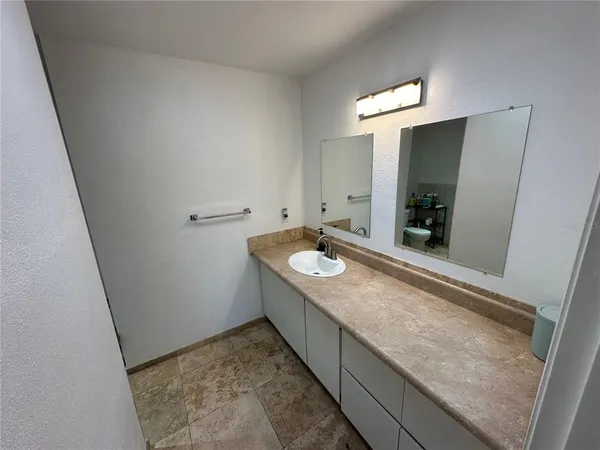 a bathroom with a sink and a mirror