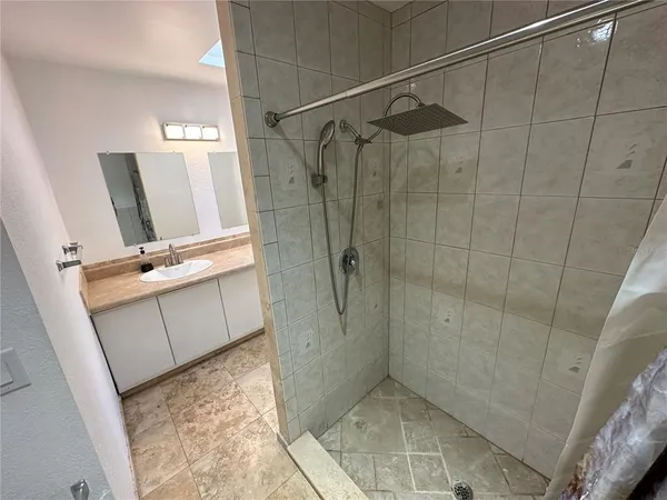 a bathroom with a shower and a sink