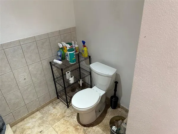 a white toilet sitting next to a sink