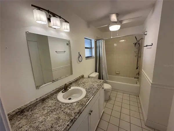 a bathroom with a sink a vanity a mirror and shower