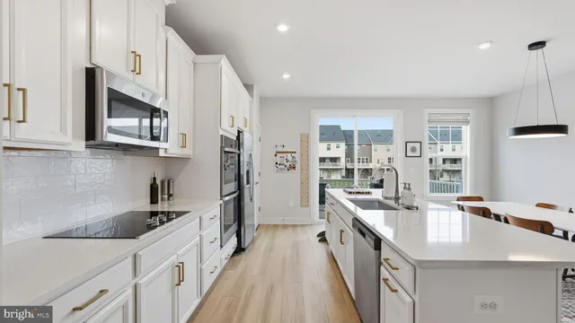 a kitchen with stainless steel appliances granite countertop a sink and stove