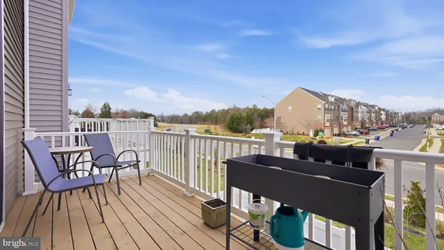 a balcony with wooden floor outdoor seating and city view