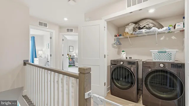 a view of a hallway with washer and dryer