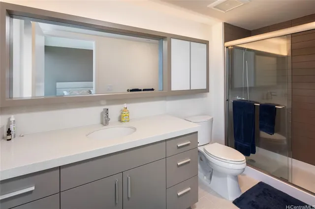 a bathroom with a sink a toilet and shower