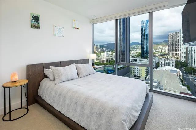 a large bed sitting in a bedroom next to a window