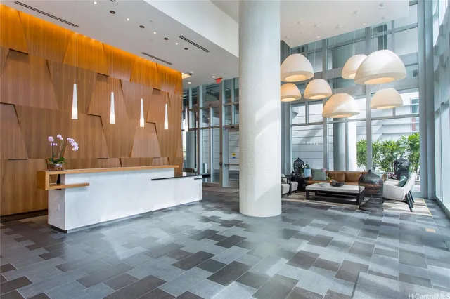a living room with furniture a large window and potted plants