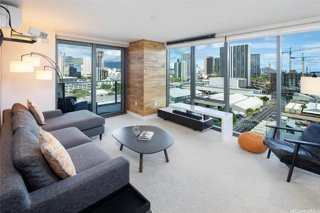 a living room with furniture and a floor to ceiling window