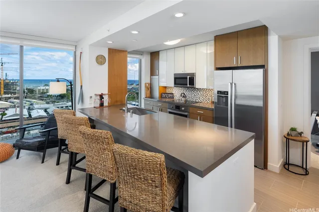 a kitchen with sink refrigerator and microwave
