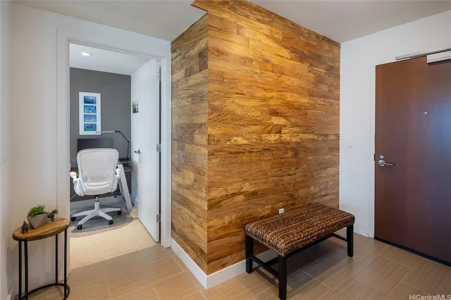 a room with a bench and a potted plant
