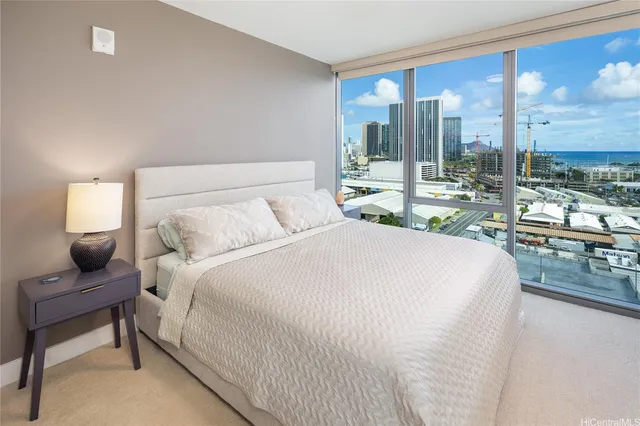 a bedroom with a large bed and a large window