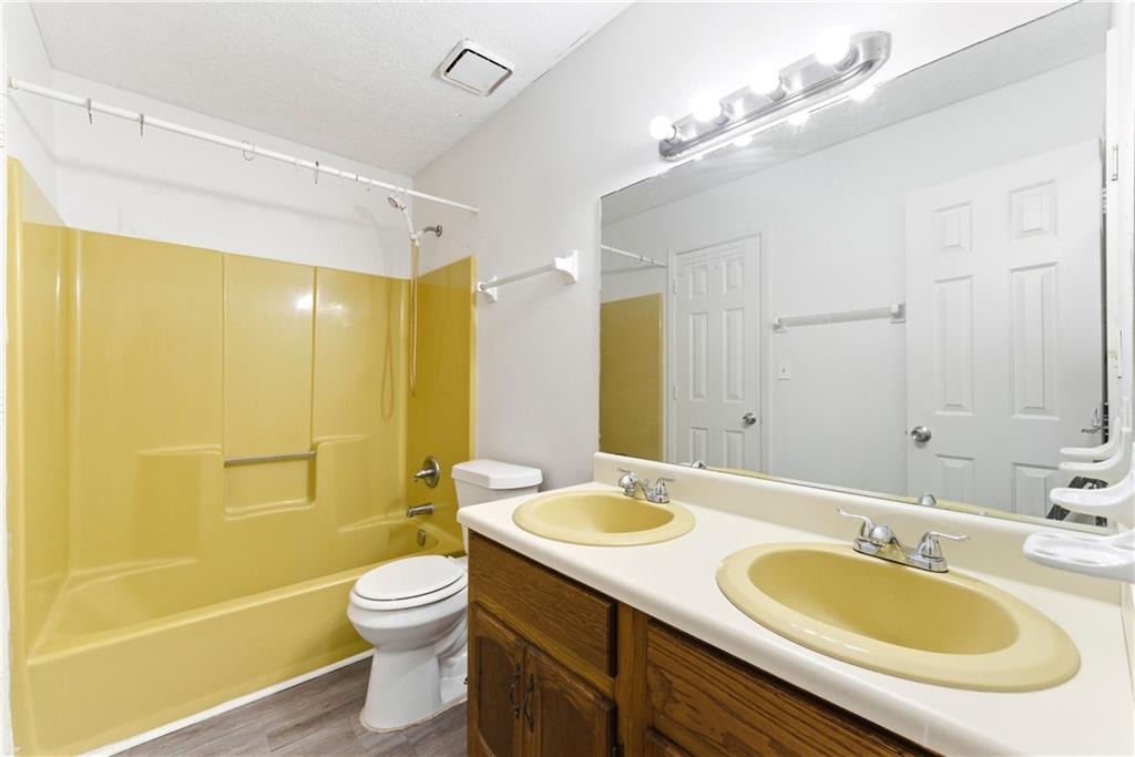 2130 Fieldstone View Court Southeast, Unit B Conyers, GA 30013 - Photo 11 of 18 a bathroom with a granite countertop sink toilet a mirror and shower