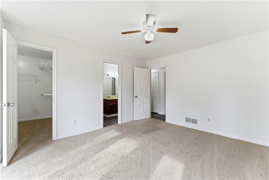 2130 Fieldstone View Court Southeast, Unit B Conyers, GA 30013 - Photo 13 of 18 an empty room with chandelier fan