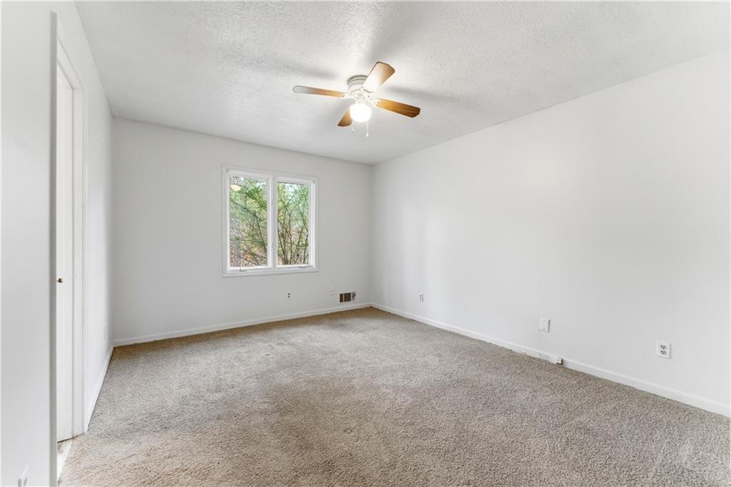 2130 Fieldstone View Court Southeast, Unit B Conyers, GA 30013 - Photo 15 of 18 an empty room with windows and fan