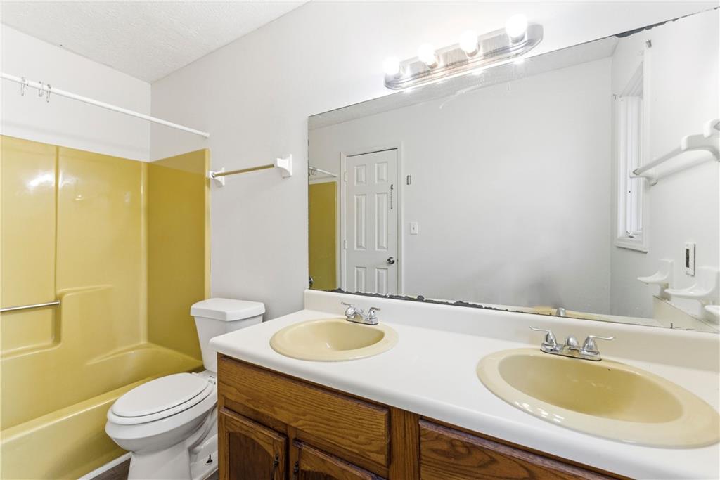 2130 Fieldstone View Court Southeast, Unit B Conyers, GA 30013 - Photo 18 of 18 a bathroom with a granite countertop sink and a mirror