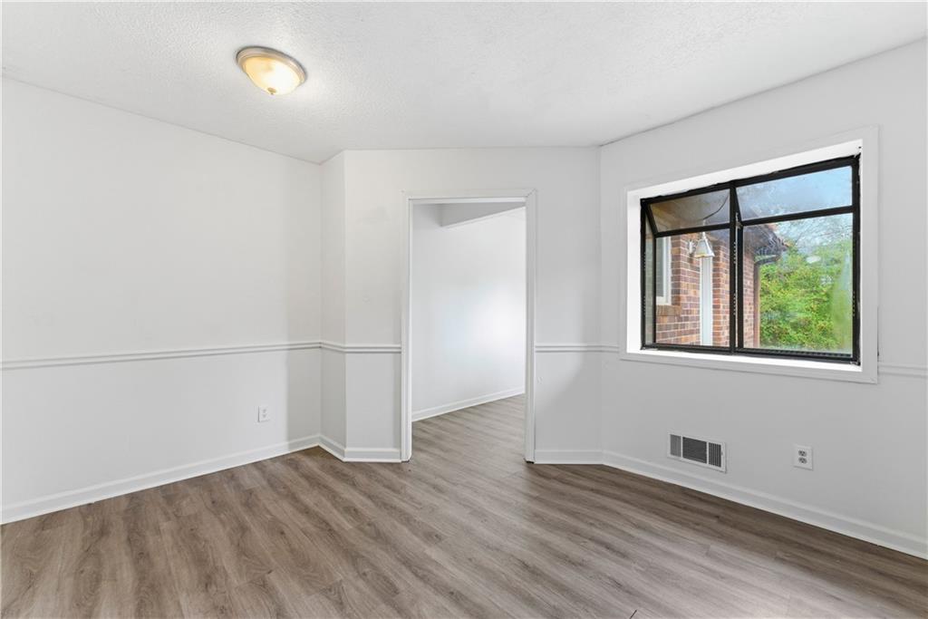 2130 Fieldstone View Court Southeast, Unit B Conyers, GA 30013 - Photo 5 of 18 an empty room with wooden floor and windows