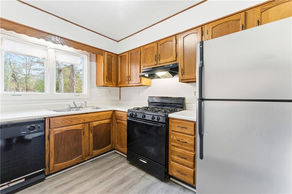 2130 Fieldstone View Court Southeast, Unit B Conyers, GA 30013 - Photo 7 of 18 a kitchen with stainless steel appliances granite countertop a stove a sink and a refrigerator