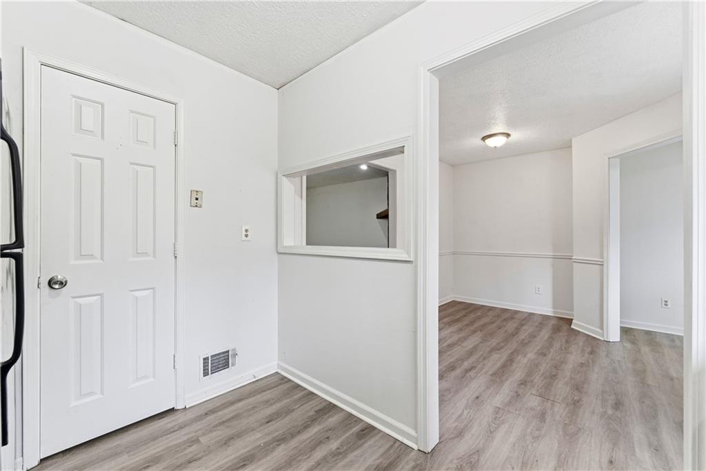 2130 Fieldstone View Court Southeast, Unit B Conyers, GA 30013 - Photo 8 of 18 an empty room with wooden floor and mirror