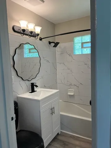 a bathroom with a sink a toilet and bathtub