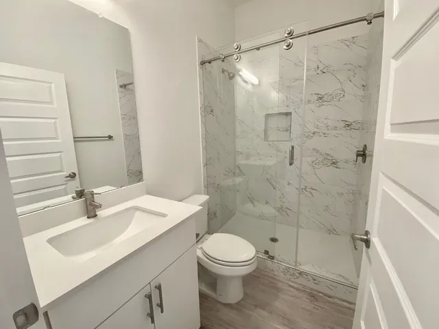 a bathroom with a sink toilet and shower