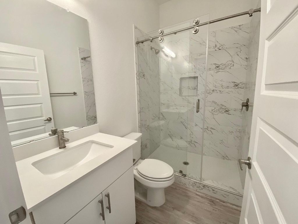 6809 Montana Street, Unit 2 Austin, TX 78741 - Photo 13 of 29 a bathroom with a sink toilet and shower